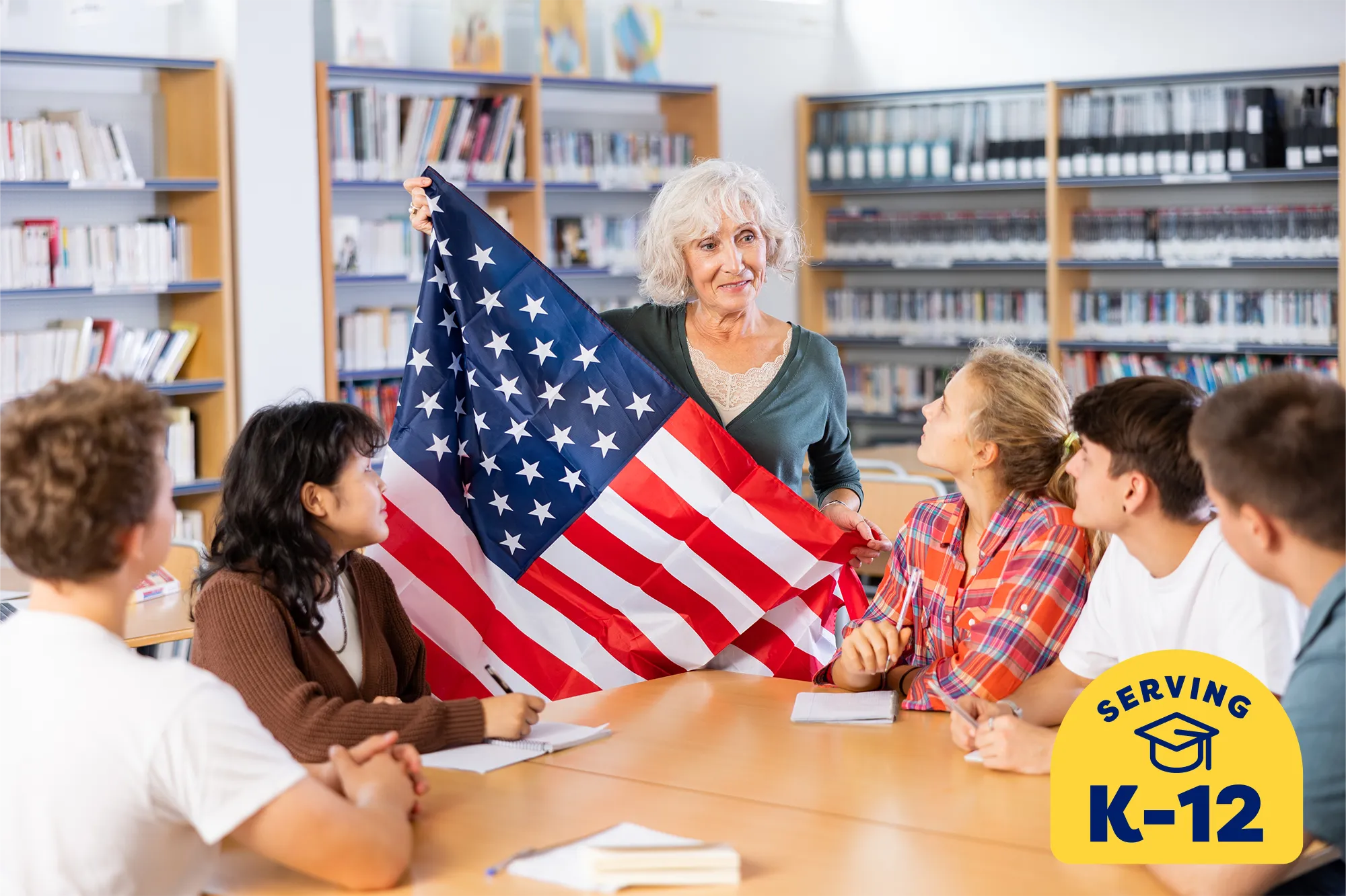 older historian teacher unfolding the American Flag to show her students